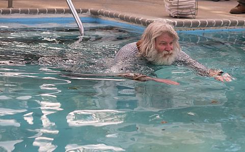 swimming wearing a Viking mail shirt